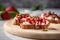 a single slice of strawberry bruschetta positioned on a granite countertop