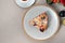 Single sliced piece of pie with plum, cinnamon and sugar powder on plate, on beige table background. Delisious dessert