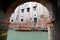 Single small boat framed by doorway, Venice Italy