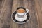 Single small coffee cup on wooden background