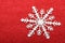 Single snowflake on red background
