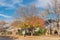 Single story bungalow houses in suburbs of Dallas with bright fall foliage colors