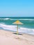 Single straw umbrella on the beach