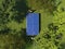 Single table tennis on the green meadow in the forest among the trees. Two people play table tennis on grass on the top view.