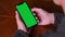 Single Tapping and Holding a Green Screen Smartphone