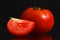 Single tomato isolated on black background