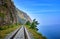 Single track railway line on edge of land between steep rock and Lake Baikal