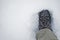 Single trekking boot on crushed ice snow cover in winter time