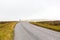 Single twisty, wavy, serpentine road with mist above in North Coast 500, Scotland