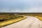 Single twisty, wavy, serpentine road with mist above in North Coast 500, Scotland