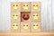 Single unhappy block and group of happy blocks symbolizing feeling lonely on wooden background