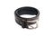 Single used black leather belt on white background.