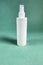 Single white blank spray plastic bottle on green