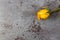 Single wilting yellow rose on a gray background