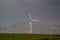A single wind turbine generating power in a field in rural Cambridgeshire