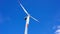 Single Wind Turbine Spins Under Blue Skies