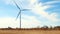 Single windmill against blue sky is seen from pov of a moving car in this hand held slow motion.