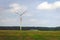 Single windmill generating electricity against blue sky.Beautiful wind turbine on blue sky clouds background