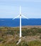 Single windmill with ocean and sky in the background.