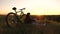 Single woman cyclist resting in park. free girl travels with a bicycle in sunset. Healthy young woman hiker sitting on