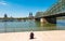 Single woman pending the time at the deutzer rhine boulevard at a summer day in Cologne