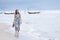 Single woman walking lonely with sorrow face on sea beach