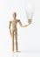 Single wooden dummy with light bulb, idea,