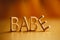 Single word `babe` in gold lettering