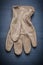 Single working glove on blue wooden board