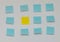 Single yellow post it note in sea of blue post it notes