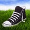 Single youth sneakers on a green grass