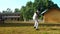 Sinhalese schoolboys in white uniform play cricket