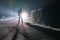 A sinister male figure standing in front of a car. On a spooky country road on a foggy night