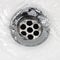 Sink plug drain hole bath plughole, white basin spout, running water macro closeup, stainless steel, china porcelain hand
