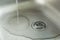 A Sink With Waterdrops, Water Jet And Chrome Drain Strainer