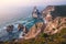 Sintra, Portugal. Praia da Ursa or Ursa Beach impressive unique sea stacks and cliffs in evening sunset light on