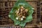 Siomay - Indonesian dish with steamed fish dumpling and vegetables served in peanut sauce in banana leaf - centered