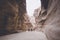 Siq, the narrow slot-canyon that serves as the entrance passage to the hidden city of Petra, Jordan, seen here with tourists