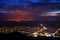 Siria village seen from the Siria Fortress at night. The bright lights of the city Arad in the background.