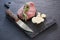 Sirloin chop, knife and garlic on slate plate