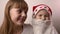 Sister and brother with artificial beard in Santa Claus hat smile, laugh together