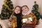 Sister and brother in knitted clothes with presents under golden