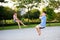 Sister and brother in playground swing