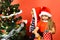 Sister and brother siblings hold little boxes near Christmas tree