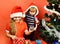 Sister and brother siblings hold toys for Christmas tree