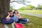 Sister firends girls relaxed under tree park after school