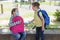 Sister, a girl gives a protective medical mask to her brother. Communication of children during the coronavirus epidemic. The new