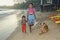 A sister with her brother walk on the beach