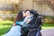 Sister kissing and hugging disabled little brother in wheelchair