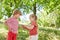 Sister showing medal to brother in garden